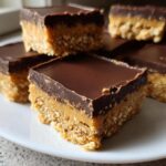 Close-up of rich, layered Buckeye Graham Crackers bars topped with smooth chocolate ganache.
