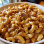 Close-up of creamy french onion pasta made with elbow macaroni and caramelized onions in a white bowl.