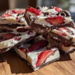 Stack of rich Chocolate Covered Strawberry Bark pieces featuring dark chocolate, white chocolate, and fresh strawberry slices.