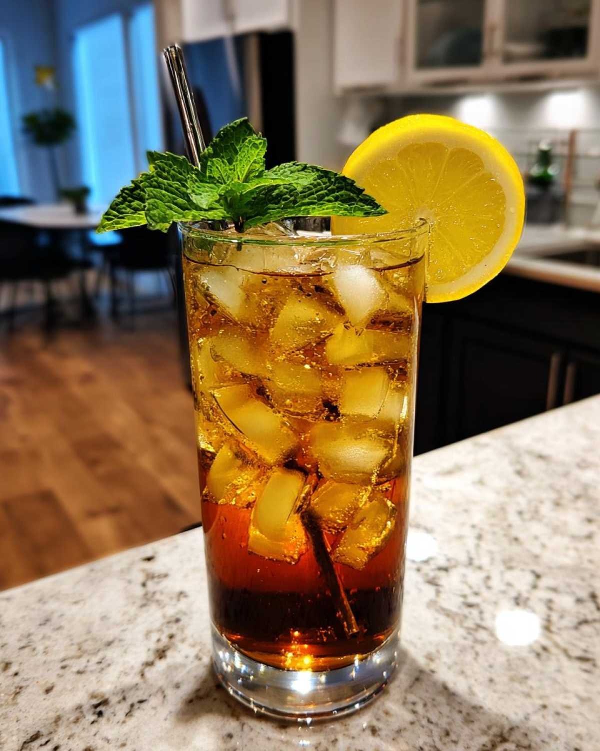 A tall glass filled with ice and Cold Brew Lemonade, garnished with a lemon slice and fresh mint.