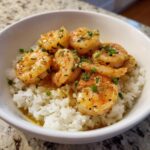 Close-up of a Garlic Butter Shrimp Bowl with Rice, featuring plump shrimp coated in garlic butter sauce over white rice.