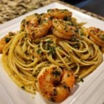 Close-up of Lemon Butter Shrimp Pasta Ready in 20 Minutes, featuring linguine tossed in sauce and topped with seasoned shrimp.