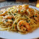 Close-up of Lemon Butter Shrimp Pasta Ready in 20 Minutes, featuring shrimp and parsley on spaghetti.