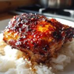Close-up of a perfectly glazed Sticky Sweet Chili Chicken Thighs served over white rice.