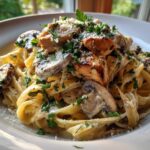 A close-up of Creamy Mushroom Garlic Pasta with Chicken, topped with parsley and Parmesan.