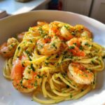 Close-up of Garlic Butter Shrimp Pasta with Lemon Flavor, featuring plump shrimp tossed with linguine and garnished with parsley and lemon zest.