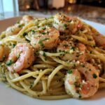 Close-up of a plate featuring Garlic Butter Shrimp Pasta with Lemon Flavor, topped with parsley and grated cheese.