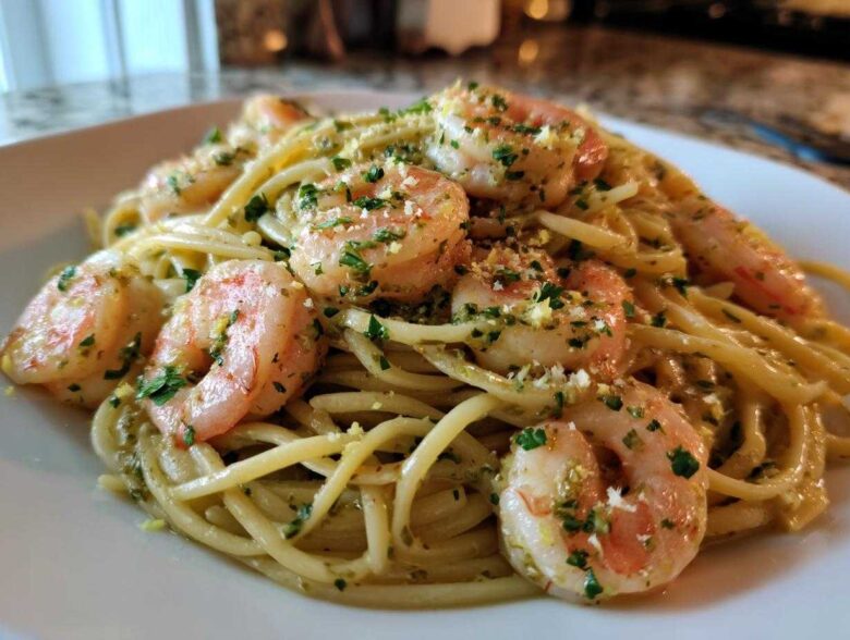 Close-up of a plate featuring Garlic Butter Shrimp Pasta with Lemon Flavor, topped with parsley and grated cheese.